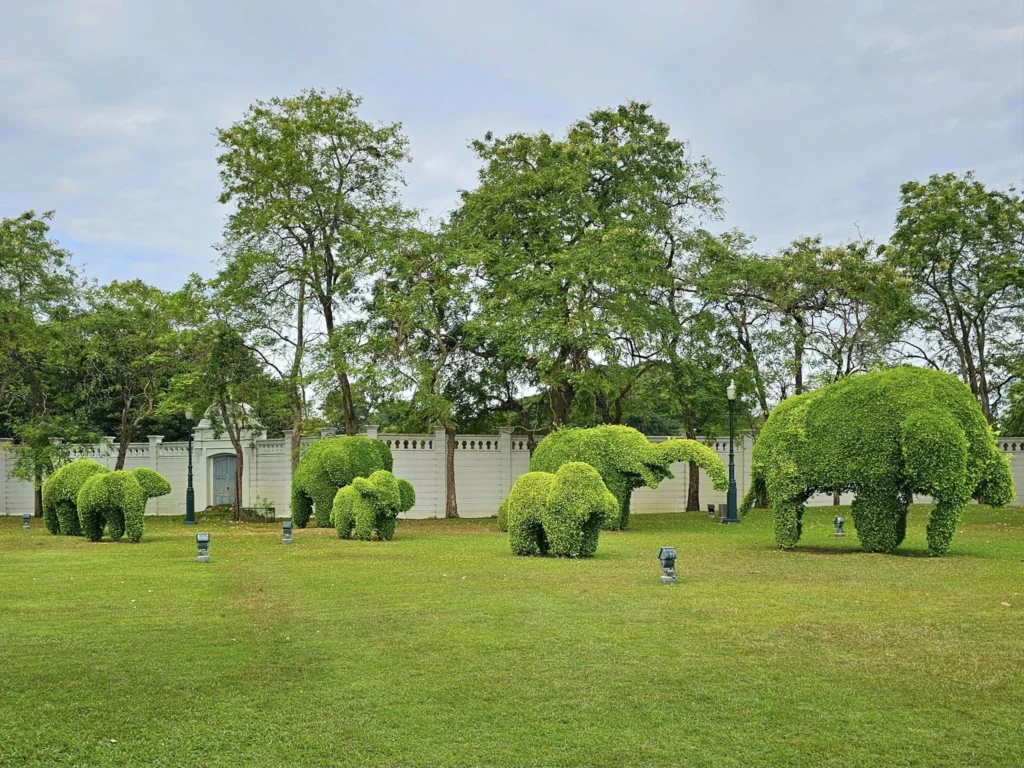 A Majestic Journey: Unveiling the Royal Historical Tour Ayutthaya from the Holland America Cruise 31 Cruising with Danny and Peter, Holland America Line, Westerdam, Laem Chabang, Bangkok, Thailand, Royal Historical Tour Ayutthaya 5 Glorious Stops | Exploring the Royal Historical Tour Ayutthaya and Bang Pa In Ayutthaya with lush gardens at Bang Pa In Palace, the elegant Aisawan Dhipaya Pavilion on a tranquil lake, towering stupa and Buddha statues at Ayutthaya Temples, colorful Traditional Thai Cuisine, and the iconic Buddha head in tree roots at Wat Mahathat Ruins—a UNESCO Heritage Site—all part of an unforgettable Thailand Cultural Tour and Ayutthaya Day Trip from the Holland America Cruise, showcasing Thai Royal History.
