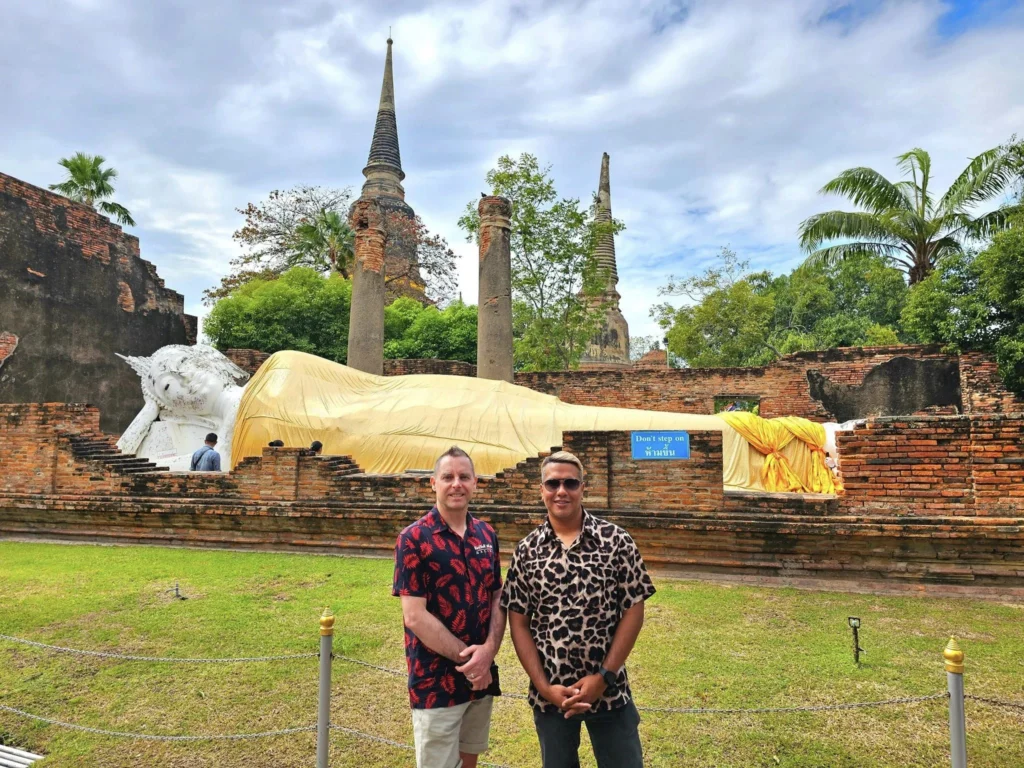 A Majestic Journey: Unveiling the Royal Historical Tour Ayutthaya from the Holland America Cruise 33 Cruising with Danny and Peter, Holland America Line, Westerdam, Laem Chabang, Bangkok, Thailand, Royal Historical Tour Ayutthaya 5 Glorious Stops | Exploring the Royal Historical Tour Ayutthaya and Bang Pa In Ayutthaya with lush gardens at Bang Pa In Palace, the elegant Aisawan Dhipaya Pavilion on a tranquil lake, towering stupa and Buddha statues at Ayutthaya Temples, colorful Traditional Thai Cuisine, and the iconic Buddha head in tree roots at Wat Mahathat Ruins—a UNESCO Heritage Site—all part of an unforgettable Thailand Cultural Tour and Ayutthaya Day Trip from the Holland America Cruise, showcasing Thai Royal History.