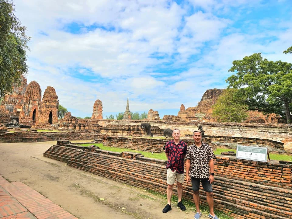 A Majestic Journey: Unveiling the Royal Historical Tour Ayutthaya from the Holland America Cruise 51 Cruising with Danny and Peter, Holland America Line, Westerdam, Laem Chabang, Bangkok, Thailand, Royal Historical Tour Ayutthaya 5 Glorious Stops | Exploring the Royal Historical Tour Ayutthaya and Bang Pa In Ayutthaya with lush gardens at Bang Pa In Palace, the elegant Aisawan Dhipaya Pavilion on a tranquil lake, towering stupa and Buddha statues at Ayutthaya Temples, colorful Traditional Thai Cuisine, and the iconic Buddha head in tree roots at Wat Mahathat Ruins—a UNESCO Heritage Site—all part of an unforgettable Thailand Cultural Tour and Ayutthaya Day Trip from the Holland America Cruise, showcasing Thai Royal History.