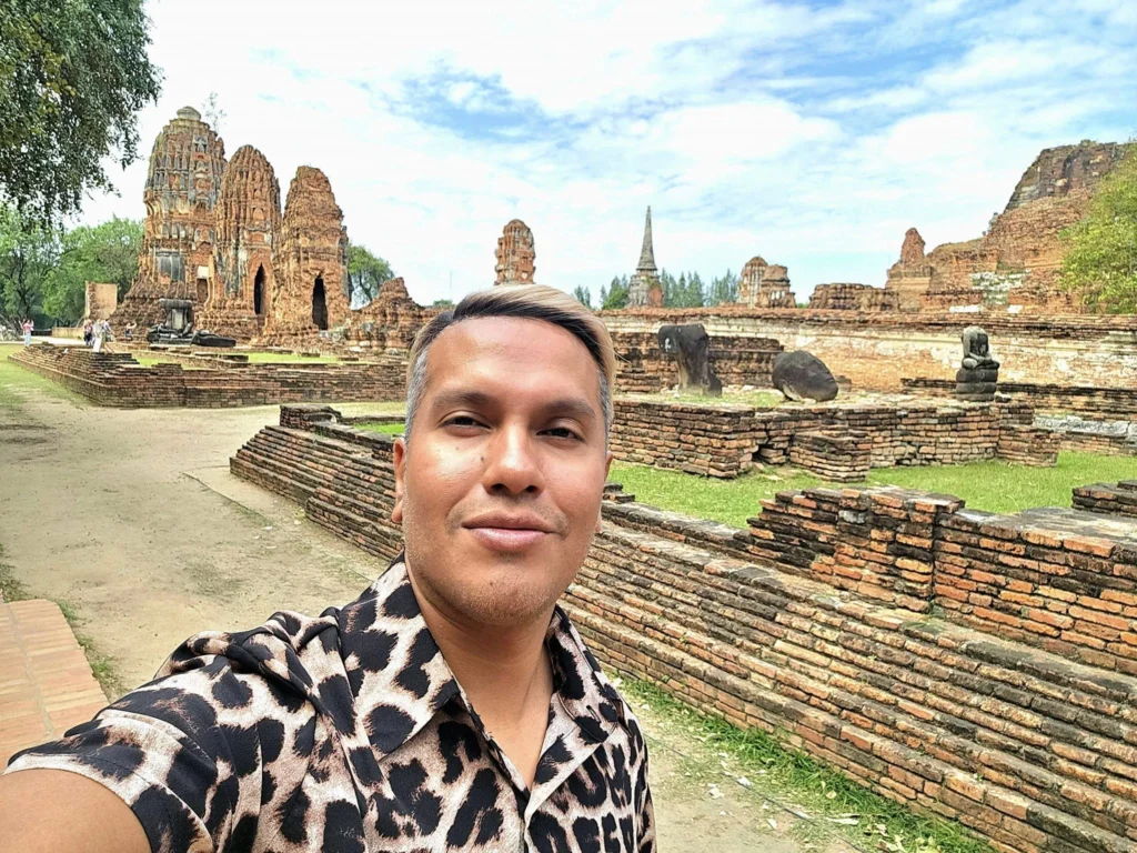 A Majestic Journey: Unveiling the Royal Historical Tour Ayutthaya from the Holland America Cruise 53 Cruising with Danny and Peter, Holland America Line, Westerdam, Laem Chabang, Bangkok, Thailand, Royal Historical Tour Ayutthaya 5 Glorious Stops | Exploring the Royal Historical Tour Ayutthaya and Bang Pa In Ayutthaya with lush gardens at Bang Pa In Palace, the elegant Aisawan Dhipaya Pavilion on a tranquil lake, towering stupa and Buddha statues at Ayutthaya Temples, colorful Traditional Thai Cuisine, and the iconic Buddha head in tree roots at Wat Mahathat Ruins—a UNESCO Heritage Site—all part of an unforgettable Thailand Cultural Tour and Ayutthaya Day Trip from the Holland America Cruise, showcasing Thai Royal History.