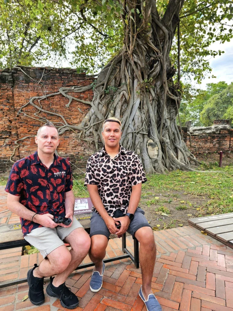 A Majestic Journey: Unveiling the Royal Historical Tour Ayutthaya from the Holland America Cruise 59 Cruising with Danny and Peter, Holland America Line, Westerdam, Laem Chabang, Bangkok, Thailand, Royal Historical Tour Ayutthaya 5 Glorious Stops | Exploring the Royal Historical Tour Ayutthaya and Bang Pa In Ayutthaya with lush gardens at Bang Pa In Palace, the elegant Aisawan Dhipaya Pavilion on a tranquil lake, towering stupa and Buddha statues at Ayutthaya Temples, colorful Traditional Thai Cuisine, and the iconic Buddha head in tree roots at Wat Mahathat Ruins—a UNESCO Heritage Site—all part of an unforgettable Thailand Cultural Tour and Ayutthaya Day Trip from the Holland America Cruise, showcasing Thai Royal History.