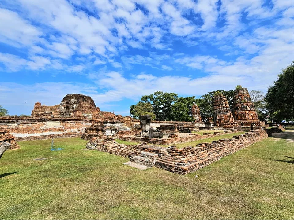 A Majestic Journey: Unveiling the Royal Historical Tour Ayutthaya from the Holland America Cruise 63 Cruising with Danny and Peter, Holland America Line, Westerdam, Laem Chabang, Bangkok, Thailand, Royal Historical Tour Ayutthaya 5 Glorious Stops | Exploring the Royal Historical Tour Ayutthaya and Bang Pa In Ayutthaya with lush gardens at Bang Pa In Palace, the elegant Aisawan Dhipaya Pavilion on a tranquil lake, towering stupa and Buddha statues at Ayutthaya Temples, colorful Traditional Thai Cuisine, and the iconic Buddha head in tree roots at Wat Mahathat Ruins—a UNESCO Heritage Site—all part of an unforgettable Thailand Cultural Tour and Ayutthaya Day Trip from the Holland America Cruise, showcasing Thai Royal History.