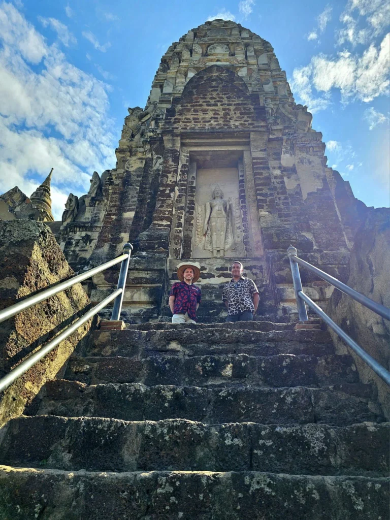 A Majestic Journey: Unveiling the Royal Historical Tour Ayutthaya from the Holland America Cruise 67 Cruising with Danny and Peter, Holland America Line, Westerdam, Laem Chabang, Bangkok, Thailand, Royal Historical Tour Ayutthaya 5 Glorious Stops | Exploring the Royal Historical Tour Ayutthaya and Bang Pa In Ayutthaya with lush gardens at Bang Pa In Palace, the elegant Aisawan Dhipaya Pavilion on a tranquil lake, towering stupa and Buddha statues at Ayutthaya Temples, colorful Traditional Thai Cuisine, and the iconic Buddha head in tree roots at Wat Mahathat Ruins—a UNESCO Heritage Site—all part of an unforgettable Thailand Cultural Tour and Ayutthaya Day Trip from the Holland America Cruise, showcasing Thai Royal History.
