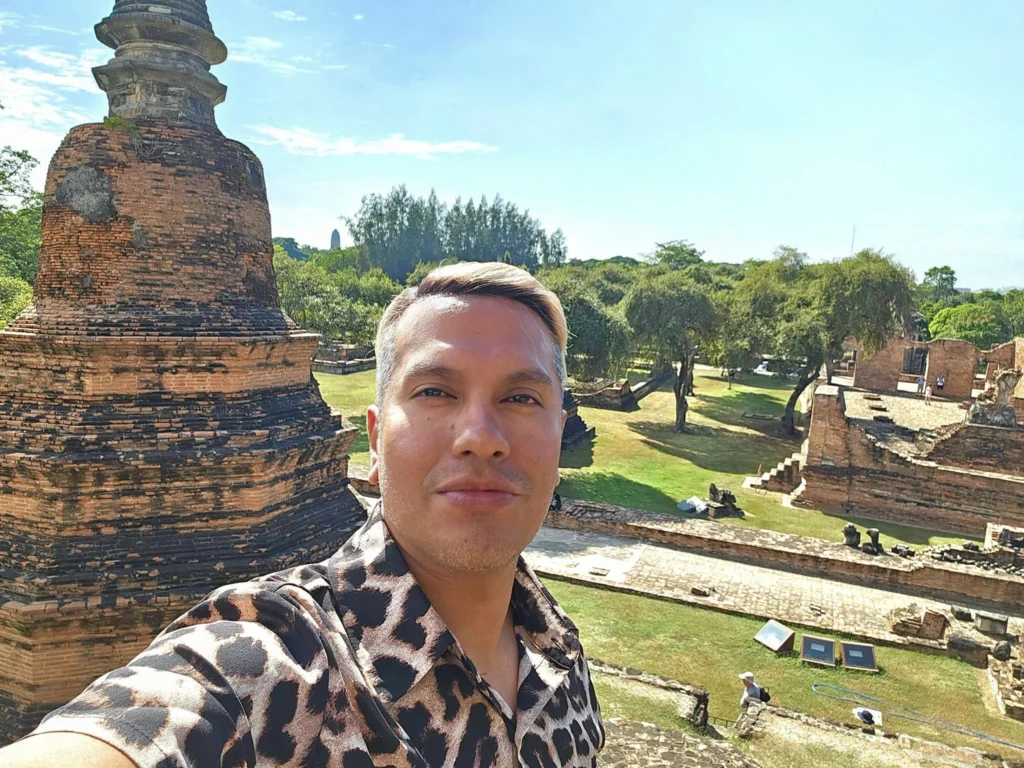 A Majestic Journey: Unveiling the Royal Historical Tour Ayutthaya from the Holland America Cruise 70 Cruising with Danny and Peter, Holland America Line, Westerdam, Laem Chabang, Bangkok, Thailand, Royal Historical Tour Ayutthaya 5 Glorious Stops | Exploring the Royal Historical Tour Ayutthaya and Bang Pa In Ayutthaya with lush gardens at Bang Pa In Palace, the elegant Aisawan Dhipaya Pavilion on a tranquil lake, towering stupa and Buddha statues at Ayutthaya Temples, colorful Traditional Thai Cuisine, and the iconic Buddha head in tree roots at Wat Mahathat Ruins—a UNESCO Heritage Site—all part of an unforgettable Thailand Cultural Tour and Ayutthaya Day Trip from the Holland America Cruise, showcasing Thai Royal History.