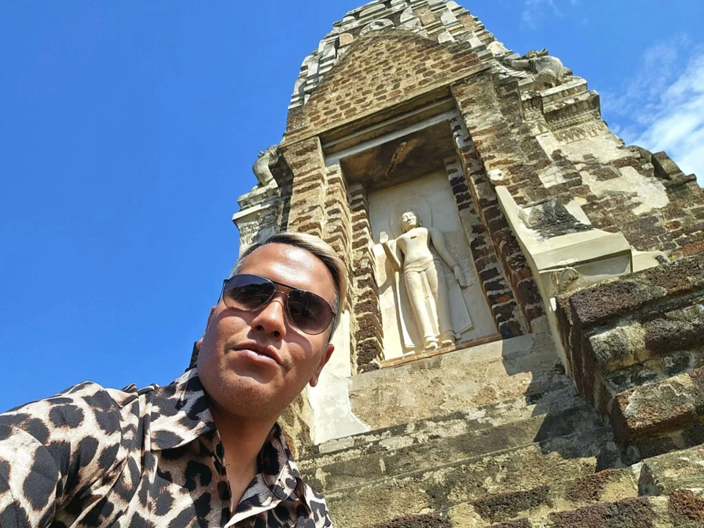 A Majestic Journey: Unveiling the Royal Historical Tour Ayutthaya from the Holland America Cruise 71 Cruising with Danny and Peter, Holland America Line, Westerdam, Laem Chabang, Bangkok, Thailand, Royal Historical Tour Ayutthaya 5 Glorious Stops | Exploring the Royal Historical Tour Ayutthaya and Bang Pa In Ayutthaya with lush gardens at Bang Pa In Palace, the elegant Aisawan Dhipaya Pavilion on a tranquil lake, towering stupa and Buddha statues at Ayutthaya Temples, colorful Traditional Thai Cuisine, and the iconic Buddha head in tree roots at Wat Mahathat Ruins—a UNESCO Heritage Site—all part of an unforgettable Thailand Cultural Tour and Ayutthaya Day Trip from the Holland America Cruise, showcasing Thai Royal History.