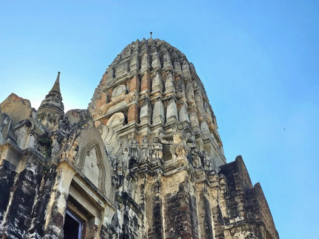 A Majestic Journey: Unveiling the Royal Historical Tour Ayutthaya from the Holland America Cruise 73 Cruising with Danny and Peter, Holland America Line, Westerdam, Laem Chabang, Bangkok, Thailand, Royal Historical Tour Ayutthaya 5 Glorious Stops | Exploring the Royal Historical Tour Ayutthaya and Bang Pa In Ayutthaya with lush gardens at Bang Pa In Palace, the elegant Aisawan Dhipaya Pavilion on a tranquil lake, towering stupa and Buddha statues at Ayutthaya Temples, colorful Traditional Thai Cuisine, and the iconic Buddha head in tree roots at Wat Mahathat Ruins—a UNESCO Heritage Site—all part of an unforgettable Thailand Cultural Tour and Ayutthaya Day Trip from the Holland America Cruise, showcasing Thai Royal History.