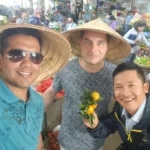 Cruising with Danny and Peter, Holland America Line, Westerdam, Nha Trang, Vietnam | Vibrant local markets in Nha Trang showcasing fresh produce and street food during a Nha Trang tour experience; scenic river cruise views with lush landscapes; delicious Vietnamese dishes like pho and banh mi from a Nha Trang food tour; historical sites featuring ancient temples and architecture in Nha Trang, Vietnam.