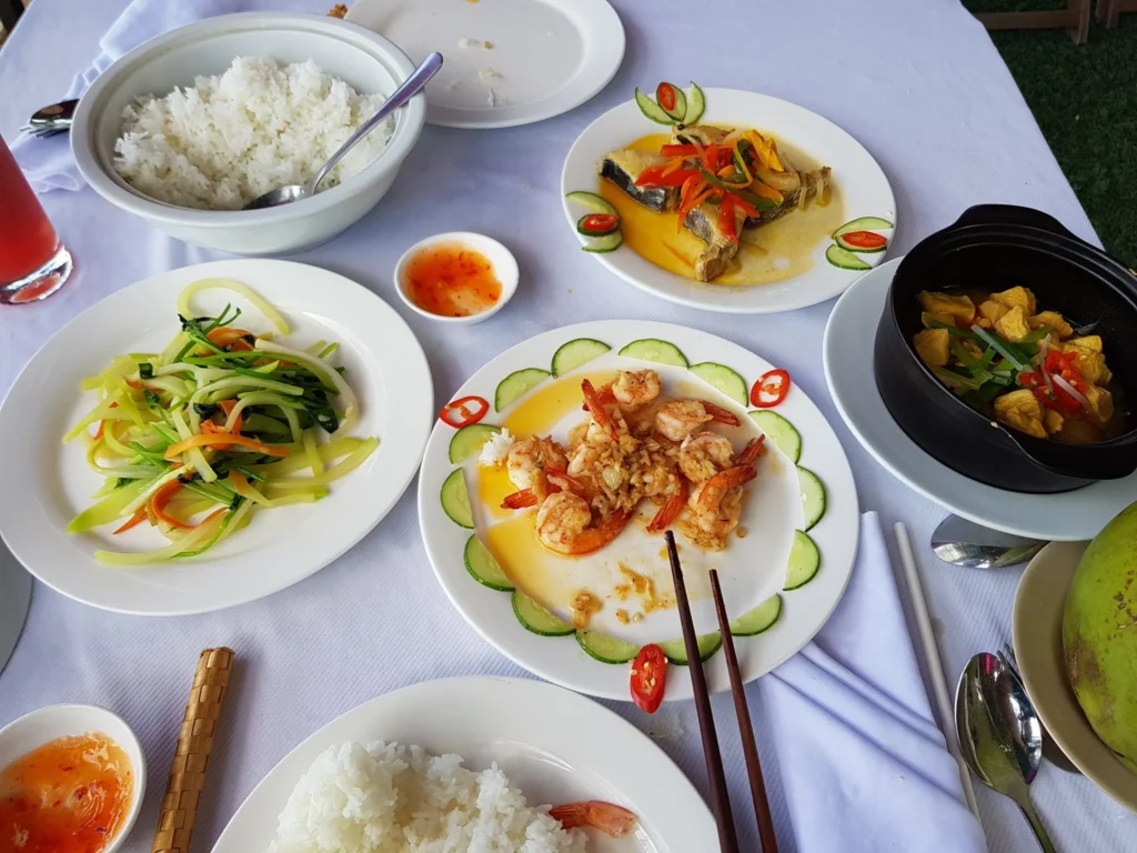 Cruising with Danny and Peter, Holland America Line, Westerdam, Nha Trang, Vietnam | Vibrant local markets in Nha Trang showcasing fresh produce and street food during a Nha Trang tour experience; scenic river cruise views with lush landscapes; delicious Vietnamese dishes like pho and banh mi from a Nha Trang food tour; historical sites featuring ancient temples and architecture in Nha Trang, Vietnam.