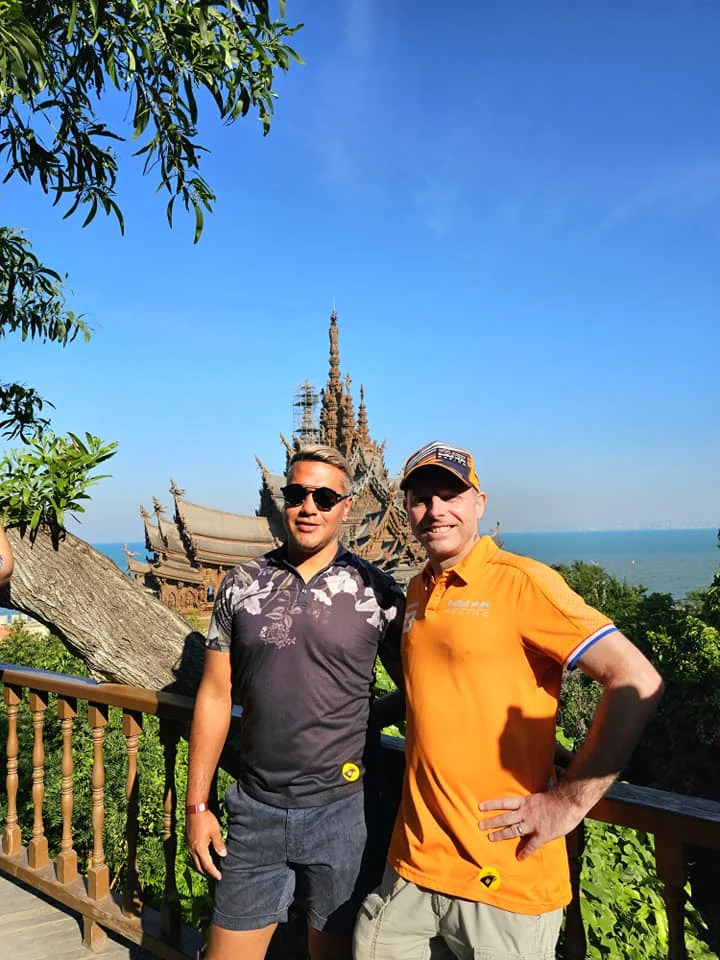Cruising with Danny and Peter, Holland America Line, Westerdam, Laem Chabang, Bangkok, Thailand, Sanctuary Of Truth Pattaya Wonders | "Facade of the Sanctuary of Truth Pattaya showcasing intricate Thai Craftsmanship Art with towering wooden spires against a lush coastal backdrop, featuring detailed wooden carvings inside the Wooden Temple Pattaya depicting Buddhist Hindu Architecture and mythological scenes. The central hall houses a majestic wooden sculpture of a celestial deity, a highlight of Spiritual Sites Thailand and Thai Cultural Heritage. The luxurious Holland America Westerdam docked at Laem Chabang offers a Laem Chabang Excursion to explore Pattaya Cultural Landmarks, while lush greenery surrounds this Pattaya Tourist Attraction inspired by Ayutthaya Kingdom Design.