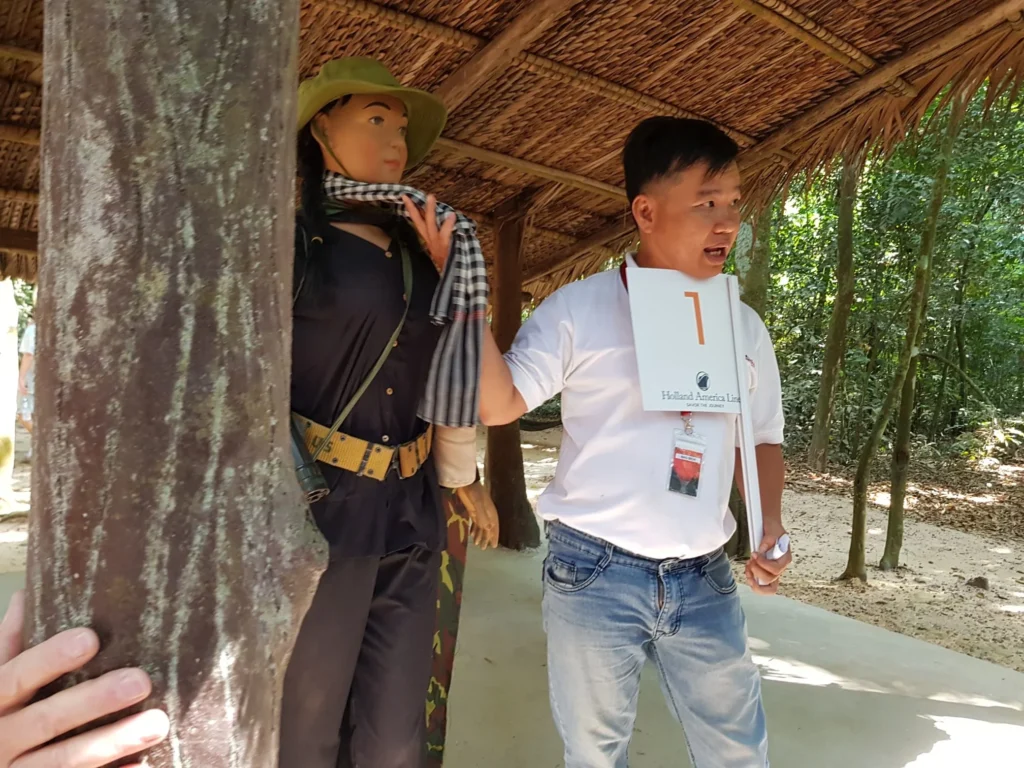 Cruising with Danny and Peter, Holland America Line, Westerdam, Phu My, Vietnam | Visitors exploring the Cu Chi Tunnels, a historic underground network used during the Vietnam War near Ho Chi Minh City, showcasing the Viet Cong's guerrilla tactics and the resilience of the Vietnamese people. The intricate tunnels of Cu Chi, complete with living quarters, are an iconic part of Vietnam's cultural heritage and historical sites, providing insight into underground warfare and the country's wartime history.