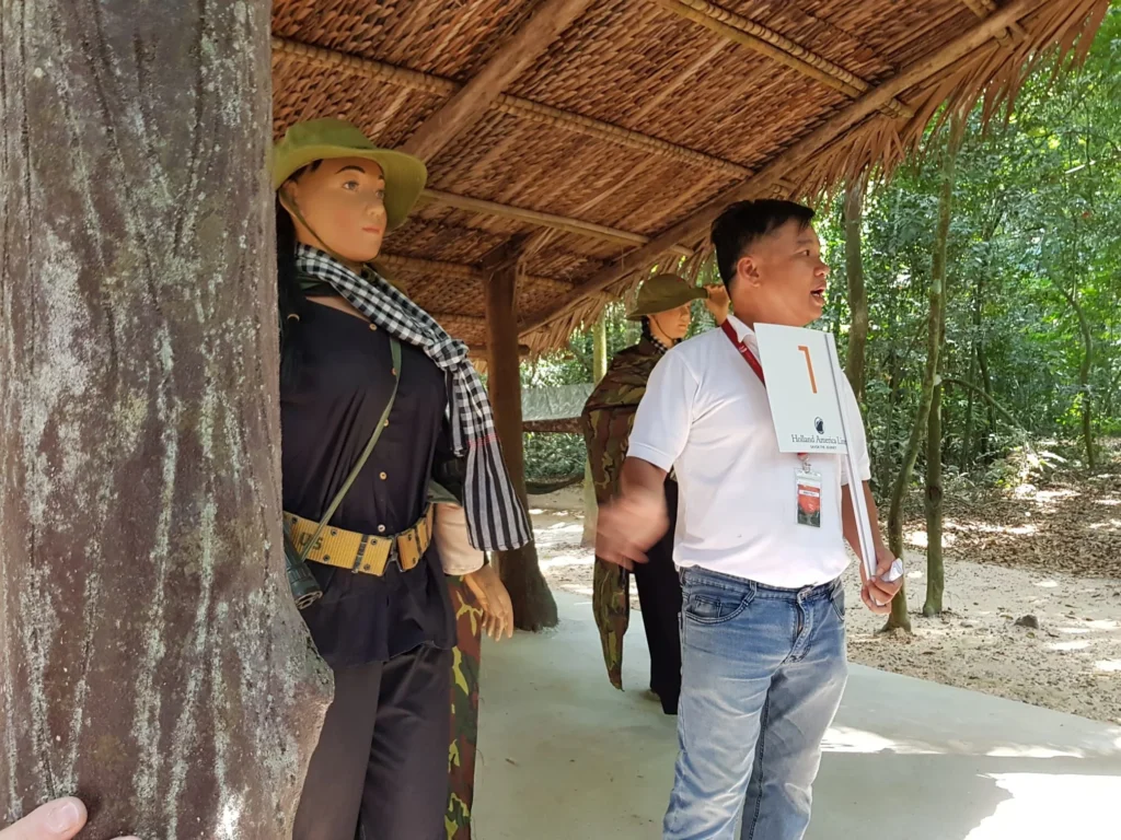 Cruising with Danny and Peter, Holland America Line, Westerdam, Phu My, Vietnam | Visitors exploring the Cu Chi Tunnels, a historic underground network used during the Vietnam War near Ho Chi Minh City, showcasing the Viet Cong's guerrilla tactics and the resilience of the Vietnamese people. The intricate tunnels of Cu Chi, complete with living quarters, are an iconic part of Vietnam's cultural heritage and historical sites, providing insight into underground warfare and the country's wartime history.