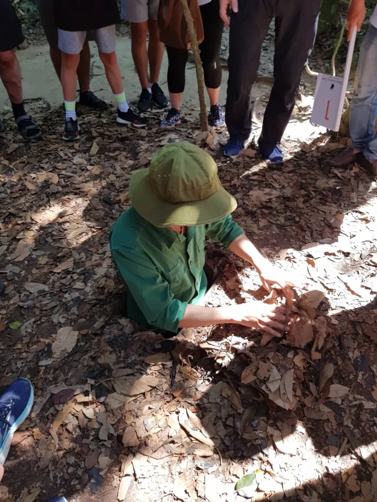 Cruising with Danny and Peter, Holland America Line, Westerdam, Phu My, Vietnam | Visitors exploring the Cu Chi Tunnels, a historic underground network used during the Vietnam War near Ho Chi Minh City, showcasing the Viet Cong's guerrilla tactics and the resilience of the Vietnamese people. The intricate tunnels of Cu Chi, complete with living quarters, are an iconic part of Vietnam's cultural heritage and historical sites, providing insight into underground warfare and the country's wartime history.