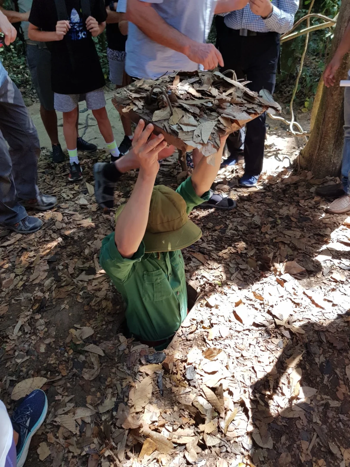 Cruising with Danny and Peter, Holland America Line, Westerdam, Phu My, Vietnam | Visitors exploring the Cu Chi Tunnels, a historic underground network used during the Vietnam War near Ho Chi Minh City, showcasing the Viet Cong's guerrilla tactics and the resilience of the Vietnamese people. The intricate tunnels of Cu Chi, complete with living quarters, are an iconic part of Vietnam's cultural heritage and historical sites, providing insight into underground warfare and the country's wartime history.