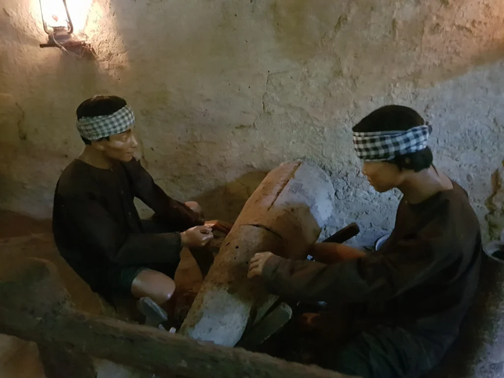 Cruising with Danny and Peter, Holland America Line, Westerdam, Phu My, Vietnam | Visitors exploring the Cu Chi Tunnels, a historic underground network used during the Vietnam War near Ho Chi Minh City, showcasing the Viet Cong's guerrilla tactics and the resilience of the Vietnamese people. The intricate tunnels of Cu Chi, complete with living quarters, are an iconic part of Vietnam's cultural heritage and historical sites, providing insight into underground warfare and the country's wartime history.