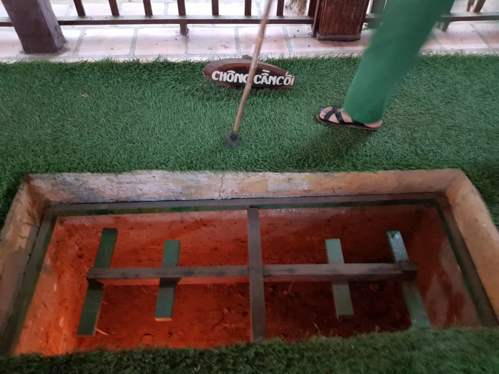 Cruising with Danny and Peter, Holland America Line, Westerdam, Phu My, Vietnam | Visitors exploring the Cu Chi Tunnels, a historic underground network used during the Vietnam War near Ho Chi Minh City, showcasing the Viet Cong's guerrilla tactics and the resilience of the Vietnamese people. The intricate tunnels of Cu Chi, complete with living quarters, are an iconic part of Vietnam's cultural heritage and historical sites, providing insight into underground warfare and the country's wartime history.