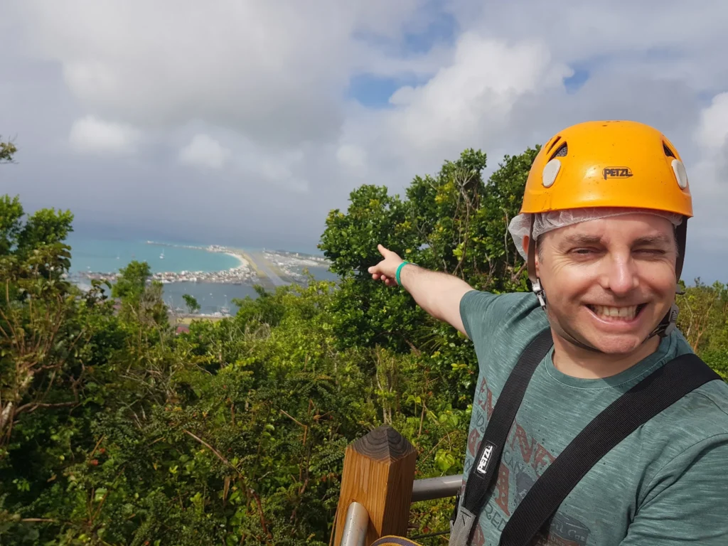 Cruising with Danny and Peter, Holland America Line, Zuiderdam, Philipsburg, Sint-Maarten | Adventurers soaring through the sky on the Philipsburg zip-line, enjoying breathtaking scenic views of lush Caribbean landscapes, turquoise waters, and the charming architecture of Philipsburg during an exhilarating aerial adventure.