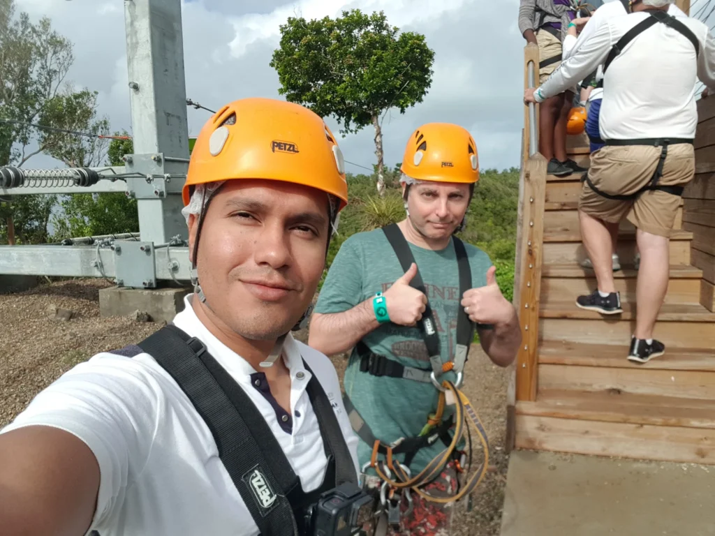 Cruising with Danny and Peter, Holland America Line, Zuiderdam, Philipsburg, Sint-Maarten | Adventurers soaring through the sky on the Philipsburg zip-line, enjoying breathtaking scenic views of lush Caribbean landscapes, turquoise waters, and the charming architecture of Philipsburg during an exhilarating aerial adventure.