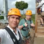 Cruising with Danny and Peter, Holland America Line, Zuiderdam, Philipsburg, Sint-Maarten | Adventurers soaring through the sky on the Philipsburg zip-line, enjoying breathtaking scenic views of lush Caribbean landscapes, turquoise waters, and the charming architecture of Philipsburg during an exhilarating aerial adventure.