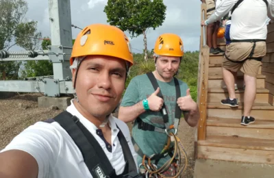 Cruising with Danny and Peter, Holland America Line, Zuiderdam, Philipsburg, Sint-Maarten | Adventurers soaring through the sky on the Philipsburg zip-line, enjoying breathtaking scenic views of lush Caribbean landscapes, turquoise waters, and the charming architecture of Philipsburg during an exhilarating aerial adventure.