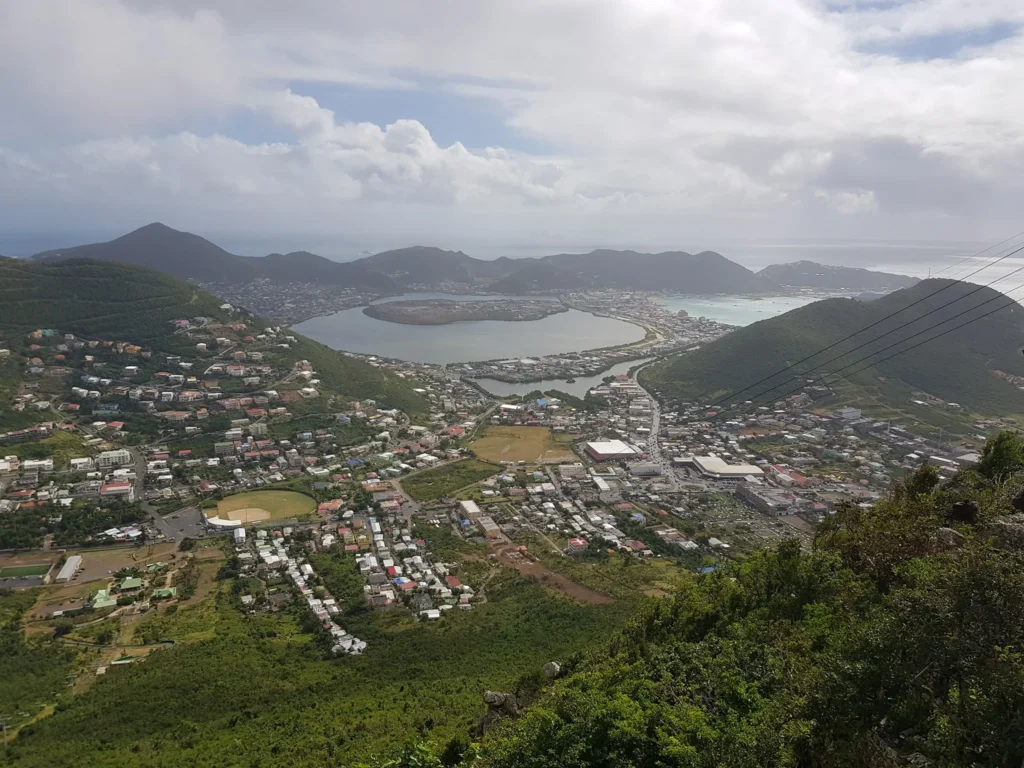 Cruising with Danny and Peter, Holland America Line, Zuiderdam, Philipsburg, Sint-Maarten | Adventurers soaring through the sky on the Philipsburg zip-line, enjoying breathtaking scenic views of lush Caribbean landscapes, turquoise waters, and the charming architecture of Philipsburg during an exhilarating aerial adventure.