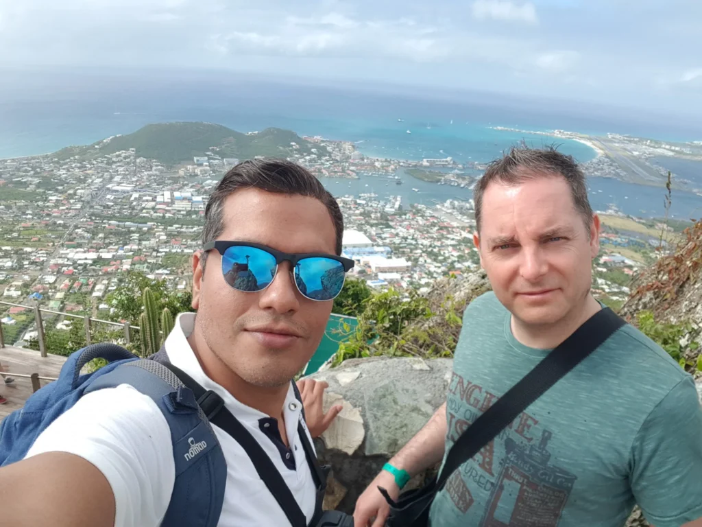 Cruising with Danny and Peter, Holland America Line, Zuiderdam, Philipsburg, Sint-Maarten | Adventurers soaring through the sky on the Philipsburg zip-line, enjoying breathtaking scenic views of lush Caribbean landscapes, turquoise waters, and the charming architecture of Philipsburg during an exhilarating aerial adventure.