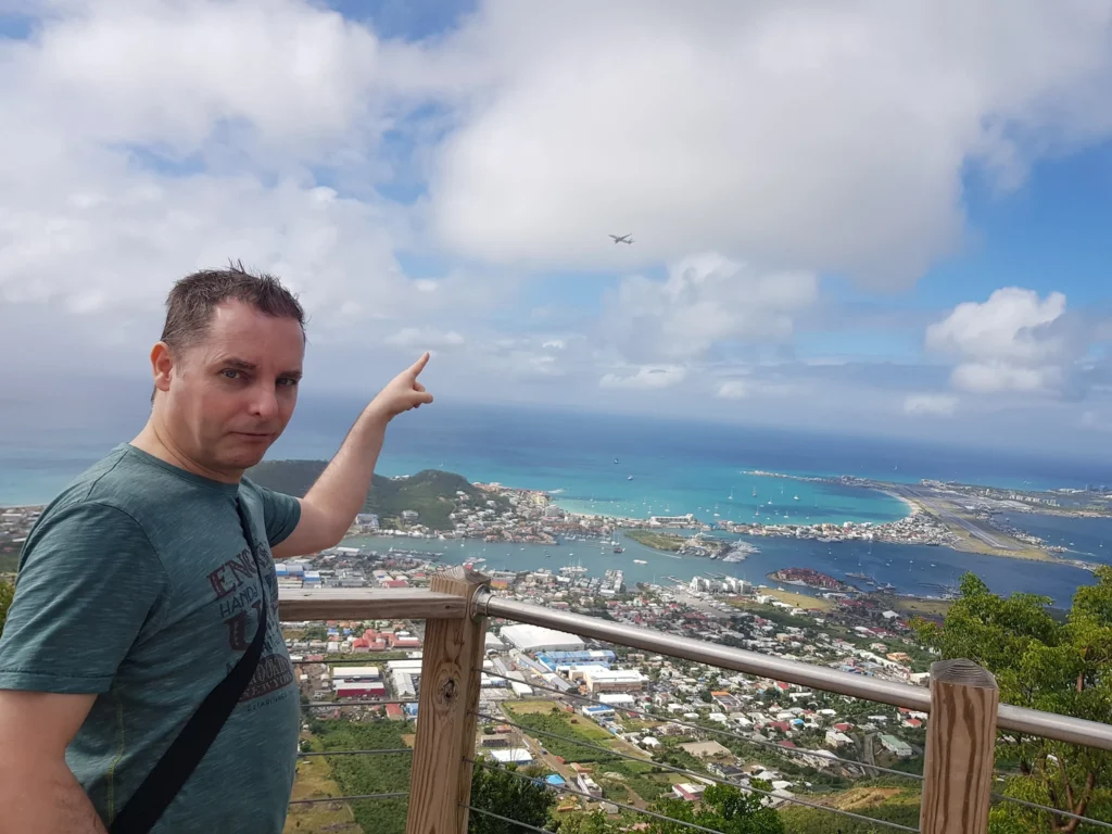 Cruising with Danny and Peter, Holland America Line, Zuiderdam, Philipsburg, Sint-Maarten | Adventurers soaring through the sky on the Philipsburg zip-line, enjoying breathtaking scenic views of lush Caribbean landscapes, turquoise waters, and the charming architecture of Philipsburg during an exhilarating aerial adventure.