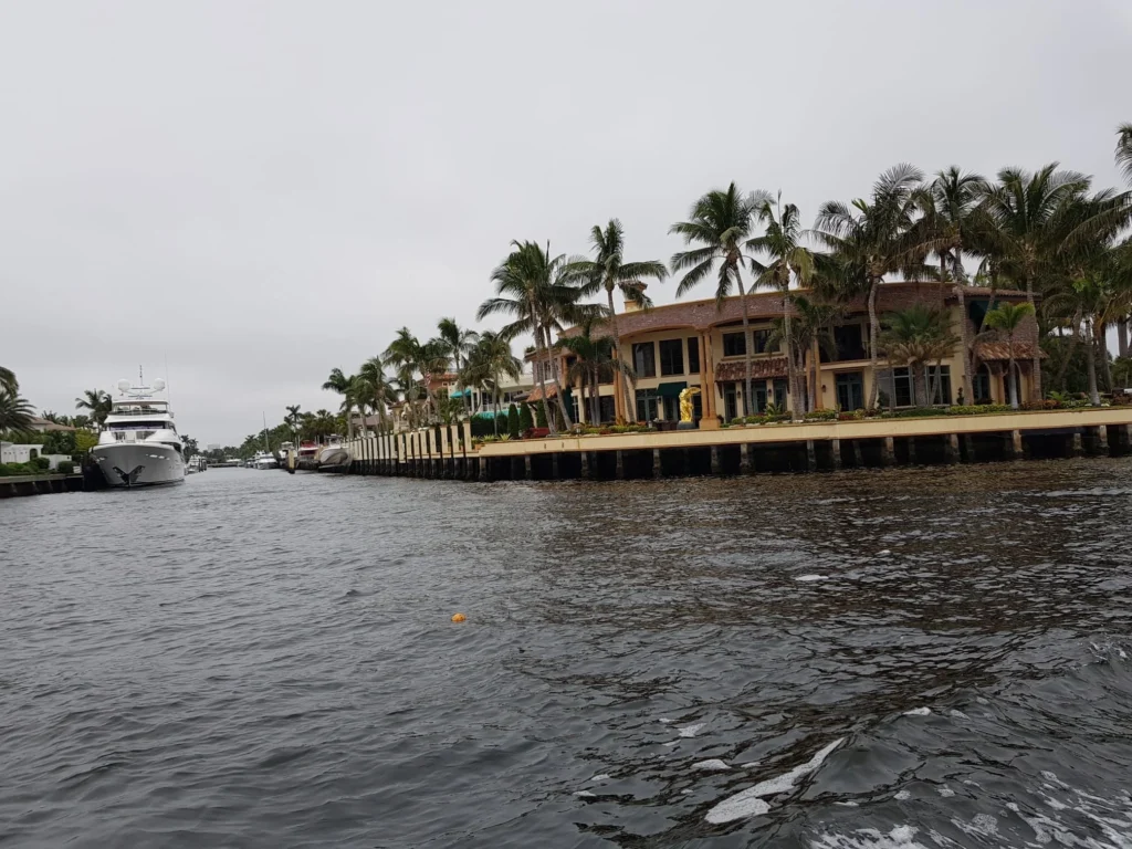 Cruising with Danny and Peter, Holland America Line, Nieuw Amsterdam, Fort Lauderdale, Florida, United States | A scenic view of a Fort Lauderdale river cruise adventure showcasing lush palm trees lining the waterways, luxury mansions along Millionaire's Row, and vibrant sunset reflections on the water, capturing the essence of a memorable canal cruise in Fort Lauderdale.