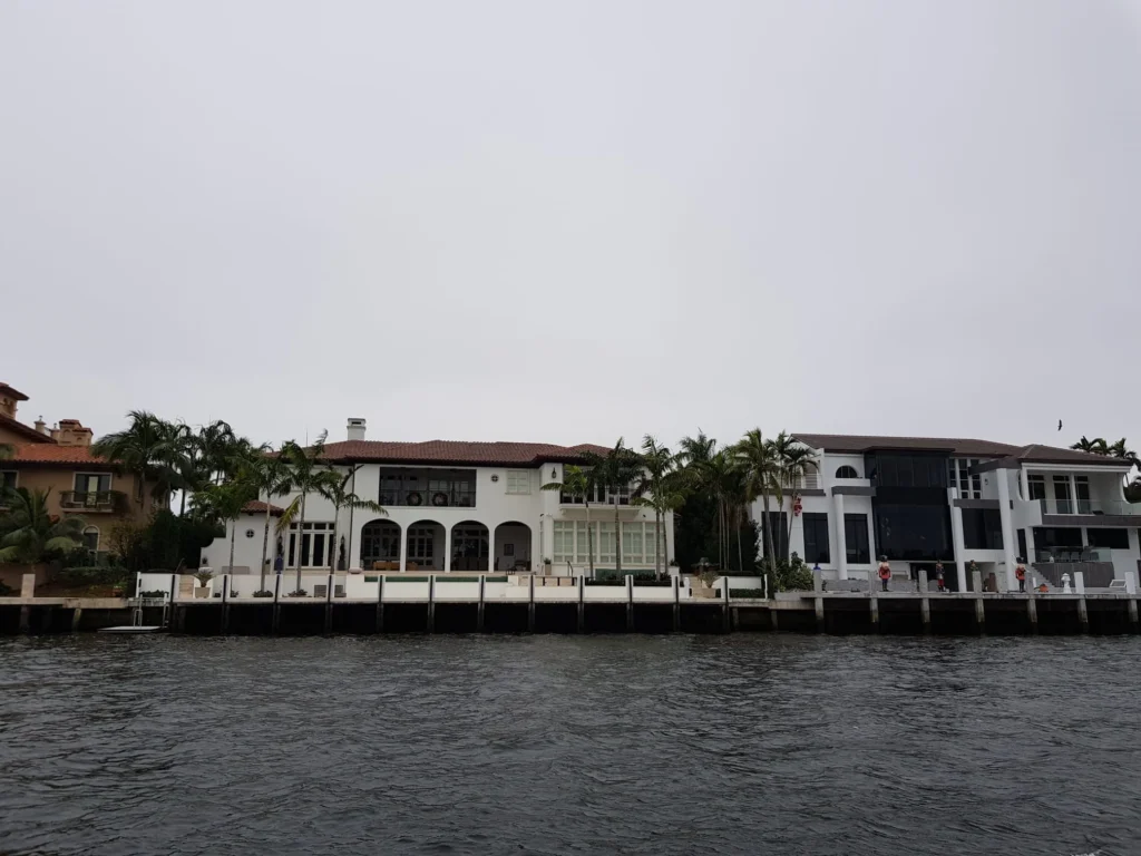 Cruising with Danny and Peter, Holland America Line, Nieuw Amsterdam, Fort Lauderdale, Florida, United States | A scenic view of a Fort Lauderdale river cruise adventure showcasing lush palm trees lining the waterways, luxury mansions along Millionaire's Row, and vibrant sunset reflections on the water, capturing the essence of a memorable canal cruise in Fort Lauderdale.