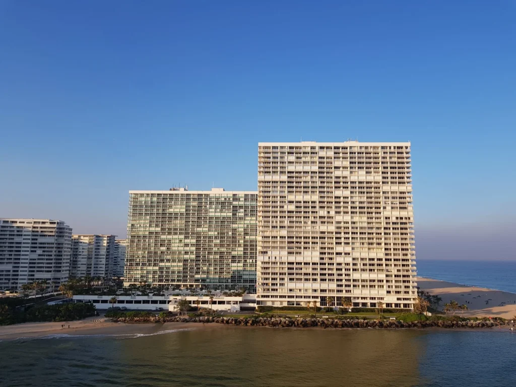 Cruising with Danny and Peter, Holland America Line, Nieuw Amsterdam, Fort Lauderdale, Florida, United States | A scenic view of a Fort Lauderdale river cruise adventure showcasing lush palm trees lining the waterways, luxury mansions along Millionaire's Row, and vibrant sunset reflections on the water, capturing the essence of a memorable canal cruise in Fort Lauderdale.