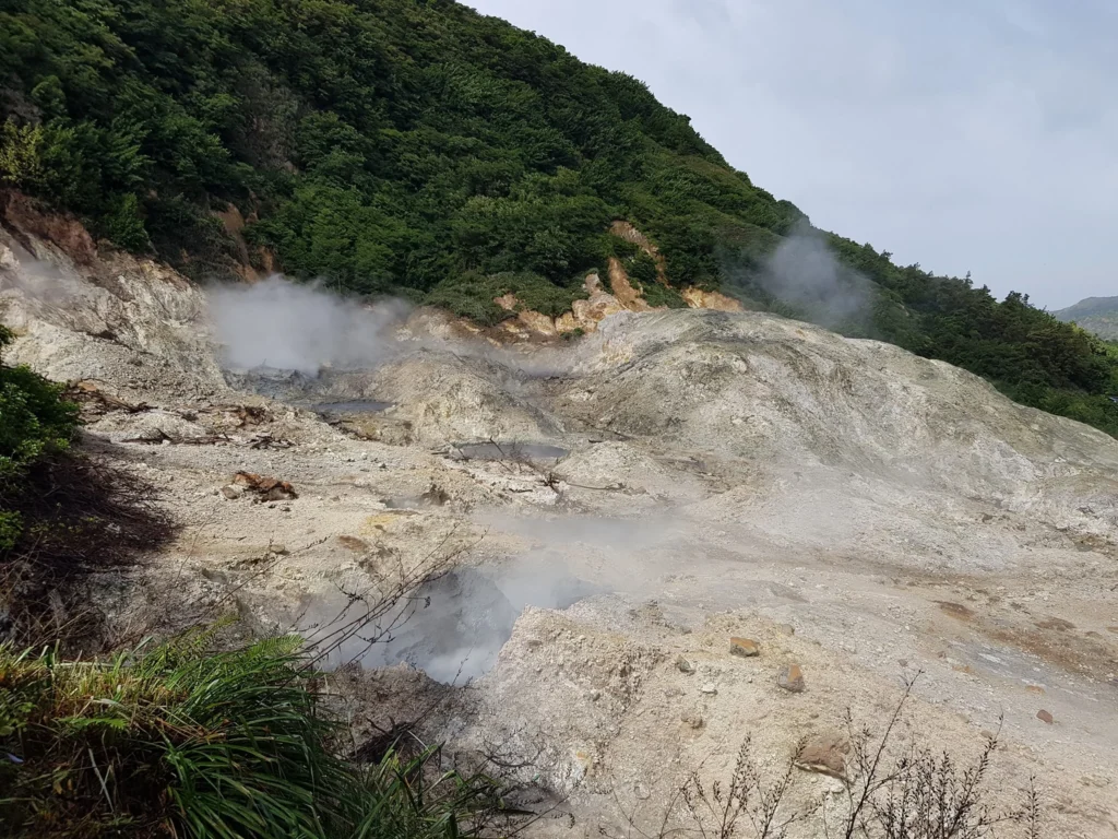 Cruising with Danny and Peter, Holland America Line, Zuiderdam, Castries, Saint Lucia | Castries Nature Expedition showcasing St. Lucia’s Black Sand Beach and Drive-In Volcano tour; includes scenic Caribbean black sand coastline, geothermal attractions with sulfur springs and mud pools, and volcanic crater views, offering an immersive St. Lucia eco-tour experience.