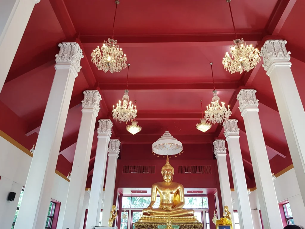Cruising with Danny and Peter, Holland America Line, Westerdam, Laem Chabang, Bangkok, Thailand | A serene view of Wat Yan Nasangwararam temple in Pattaya, showcasing intricate Thai architecture surrounded by lush greenery. In the foreground, worshippers engage in meditation and tranquility, while the majestic Khao Chi Chan Buddha monument looms in the background, radiating serenity. This scene captures the essence of a spiritual journey in Pattaya, highlighting the cultural heritage of Thai Buddhism and the beauty of religious art in Thailand.