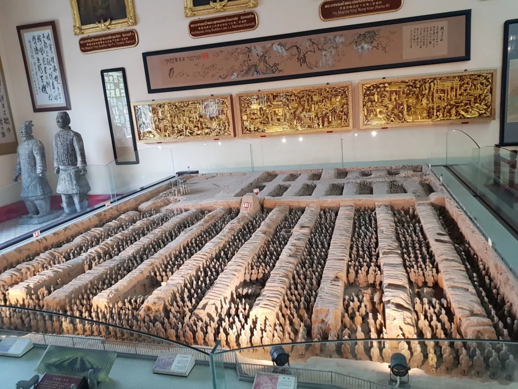 Cruising with Danny and Peter, Holland America Line, Westerdam, Laem Chabang, Bangkok, Thailand | A serene view of Wat Yan Nasangwararam temple in Pattaya, showcasing intricate Thai architecture surrounded by lush greenery. In the foreground, worshippers engage in meditation and tranquility, while the majestic Khao Chi Chan Buddha monument looms in the background, radiating serenity. This scene captures the essence of a spiritual journey in Pattaya, highlighting the cultural heritage of Thai Buddhism and the beauty of religious art in Thailand.