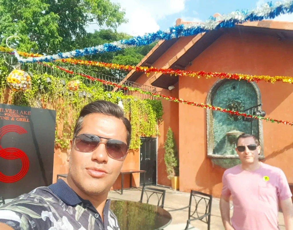 Cruising with Danny and Peter, Holland America Line, Westerdam, Laem Chabang, Bangkok, Thailand | A serene view of Wat Yan Nasangwararam temple in Pattaya, showcasing intricate Thai architecture surrounded by lush greenery. In the foreground, worshippers engage in meditation and tranquility, while the majestic Khao Chi Chan Buddha monument looms in the background, radiating serenity. This scene captures the essence of a spiritual journey in Pattaya, highlighting the cultural heritage of Thai Buddhism and the beauty of religious art in Thailand.