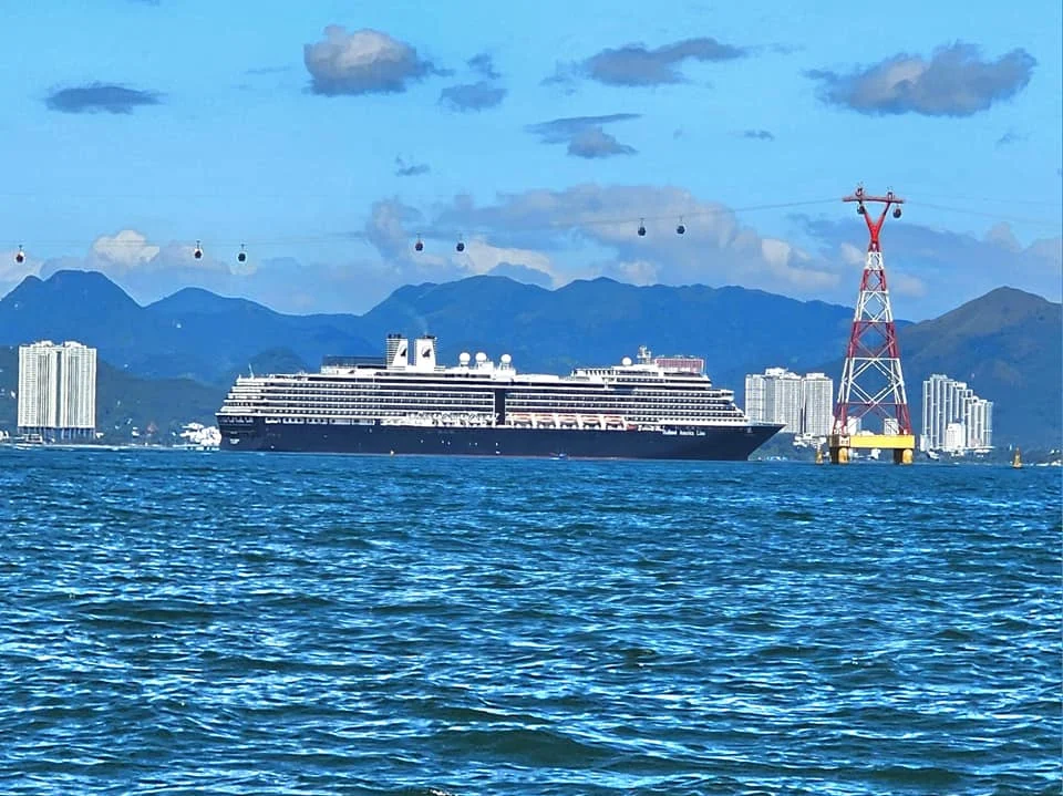 Cruising with Danny and Peter, Holland America Line, Westerdam, Nha Trang, Vietnam, Nha Trang Island Escapade Adventure | Group of tourists enjoying a Nha Trang Island Escapade Adventure featuring Mieu Island Exploration under a tropical sun, vibrant underwater scenes from Coral Reef Snorkeling in Nha Trang Bay, the pirate ship-shaped Tri Nguyen Aquarium showcasing a Marine Life Experience on a Vietnam Coastal Adventure, local fishermen feeding groupers during a Fishing Village Visit, relaxing on golden sands at Mini Beach Relaxation after a Nha Trang Island Tour with Holland America Cruise, and a scenic view of Nha Trang Bay from a boat during a Tropical Island Retreat.