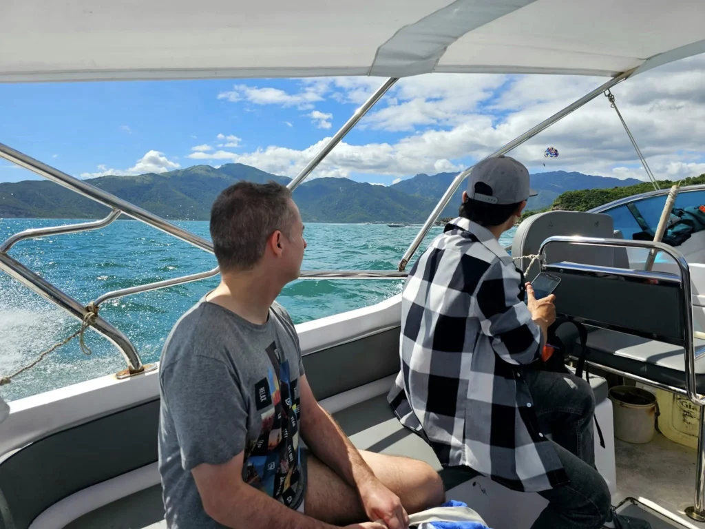 Cruising with Danny and Peter, Holland America Line, Westerdam, Nha Trang, Vietnam, Nha Trang Island Escapade Adventure | Group of tourists enjoying a Nha Trang Island Escapade Adventure featuring Mieu Island Exploration under a tropical sun, vibrant underwater scenes from Coral Reef Snorkeling in Nha Trang Bay, the pirate ship-shaped Tri Nguyen Aquarium showcasing a Marine Life Experience on a Vietnam Coastal Adventure, local fishermen feeding groupers during a Fishing Village Visit, relaxing on golden sands at Mini Beach Relaxation after a Nha Trang Island Tour with Holland America Cruise, and a scenic view of Nha Trang Bay from a boat during a Tropical Island Retreat.