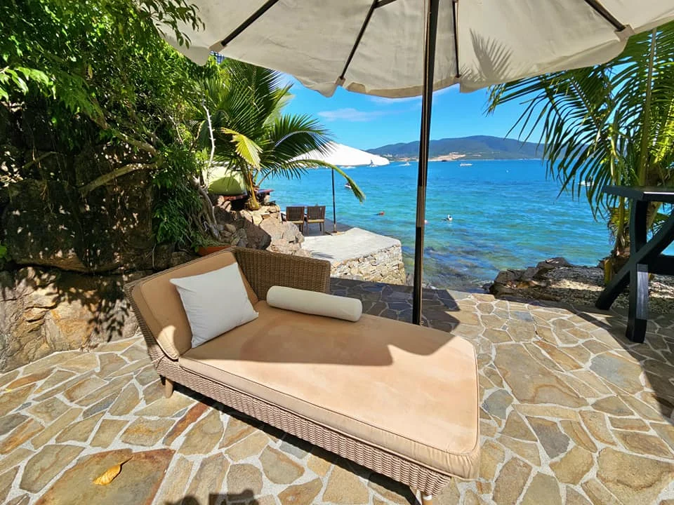 Cruising with Danny and Peter, Holland America Line, Westerdam, Nha Trang, Vietnam, Nha Trang Island Escapade Adventure | Group of tourists enjoying a Nha Trang Island Escapade Adventure featuring Mieu Island Exploration under a tropical sun, vibrant underwater scenes from Coral Reef Snorkeling in Nha Trang Bay, the pirate ship-shaped Tri Nguyen Aquarium showcasing a Marine Life Experience on a Vietnam Coastal Adventure, local fishermen feeding groupers during a Fishing Village Visit, relaxing on golden sands at Mini Beach Relaxation after a Nha Trang Island Tour with Holland America Cruise, and a scenic view of Nha Trang Bay from a boat during a Tropical Island Retreat.