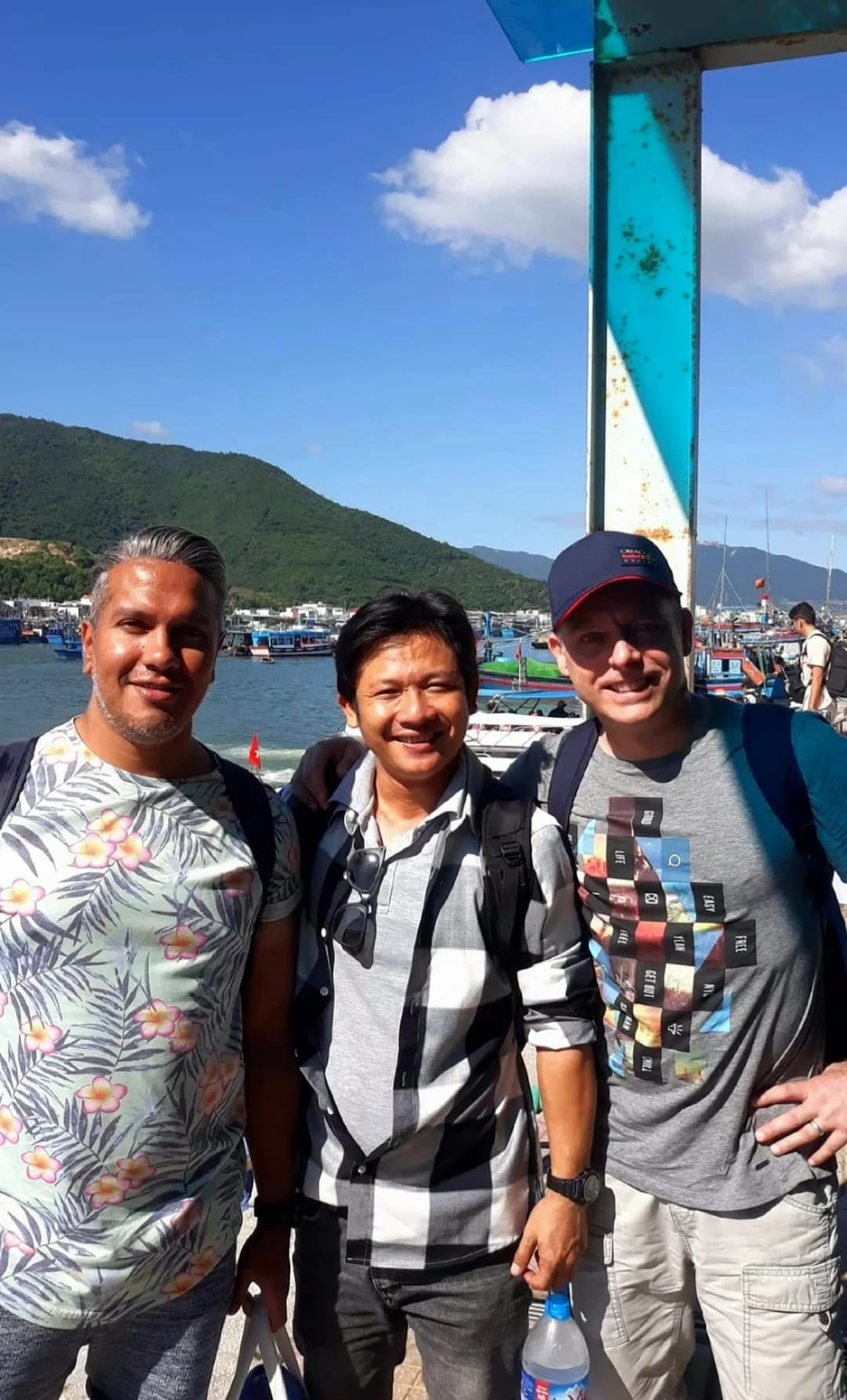 Cruising with Danny and Peter, Holland America Line, Westerdam, Nha Trang, Vietnam, Nha Trang Island Escapade Adventure | Group of tourists enjoying a Nha Trang Island Escapade Adventure featuring Mieu Island Exploration under a tropical sun, vibrant underwater scenes from Coral Reef Snorkeling in Nha Trang Bay, the pirate ship-shaped Tri Nguyen Aquarium showcasing a Marine Life Experience on a Vietnam Coastal Adventure, local fishermen feeding groupers during a Fishing Village Visit, relaxing on golden sands at Mini Beach Relaxation after a Nha Trang Island Tour with Holland America Cruise, and a scenic view of Nha Trang Bay from a boat during a Tropical Island Retreat.