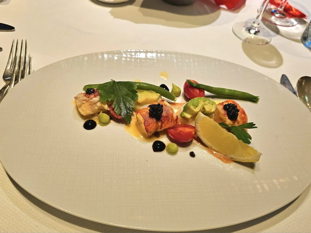 Cruising with Danny and Peter, Holland America Line, Westerdam, Nha Trang, Vietnam, Nha Trang Island Escapade Adventure | Group of tourists enjoying a Nha Trang Island Escapade Adventure featuring Mieu Island Exploration under a tropical sun, vibrant underwater scenes from Coral Reef Snorkeling in Nha Trang Bay, the pirate ship-shaped Tri Nguyen Aquarium showcasing a Marine Life Experience on a Vietnam Coastal Adventure, local fishermen feeding groupers during a Fishing Village Visit, relaxing on golden sands at Mini Beach Relaxation after a Nha Trang Island Tour with Holland America Cruise, and a scenic view of Nha Trang Bay from a boat during a Tropical Island Retreat.