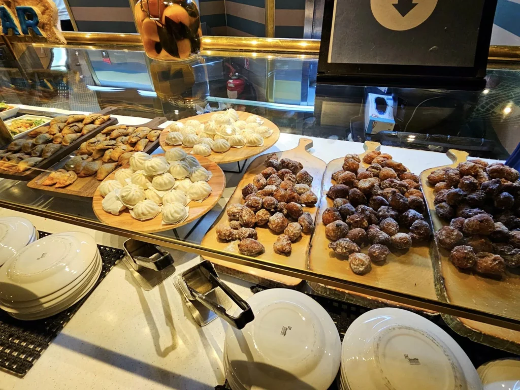 Cruising with Danny and Peter, Holland America Line, Westerdam, Nha Trang, Vietnam, Nha Trang Island Escapade Adventure | Group of tourists enjoying a Nha Trang Island Escapade Adventure featuring Mieu Island Exploration under a tropical sun, vibrant underwater scenes from Coral Reef Snorkeling in Nha Trang Bay, the pirate ship-shaped Tri Nguyen Aquarium showcasing a Marine Life Experience on a Vietnam Coastal Adventure, local fishermen feeding groupers during a Fishing Village Visit, relaxing on golden sands at Mini Beach Relaxation after a Nha Trang Island Tour with Holland America Cruise, and a scenic view of Nha Trang Bay from a boat during a Tropical Island Retreat.