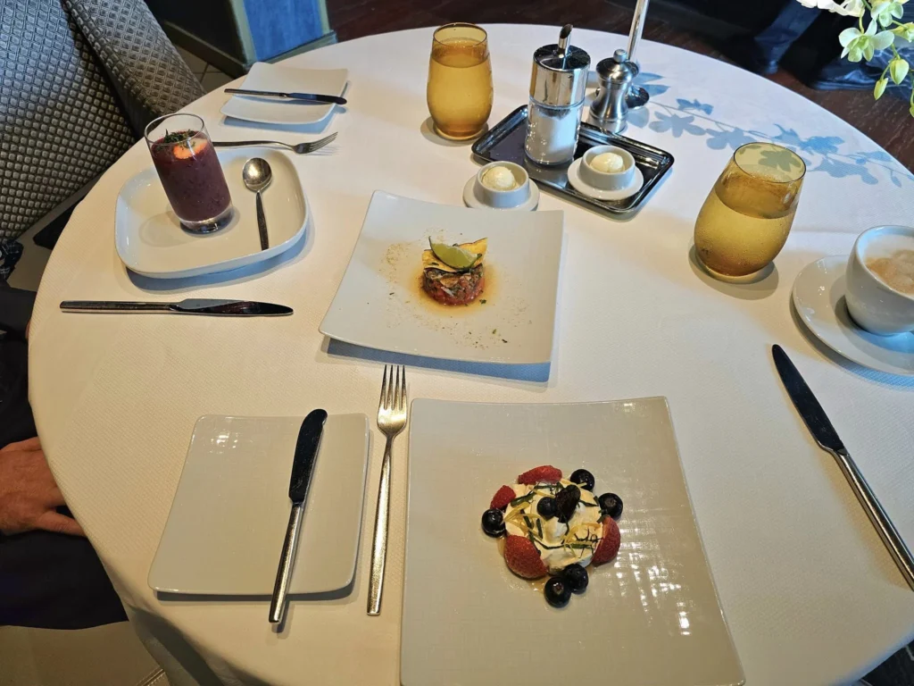 Cruising with Danny and Peter, Holland America Line, Westerdam, Nha Trang, Vietnam, Nha Trang Island Escapade Adventure | Group of tourists enjoying a Nha Trang Island Escapade Adventure featuring Mieu Island Exploration under a tropical sun, vibrant underwater scenes from Coral Reef Snorkeling in Nha Trang Bay, the pirate ship-shaped Tri Nguyen Aquarium showcasing a Marine Life Experience on a Vietnam Coastal Adventure, local fishermen feeding groupers during a Fishing Village Visit, relaxing on golden sands at Mini Beach Relaxation after a Nha Trang Island Tour with Holland America Cruise, and a scenic view of Nha Trang Bay from a boat during a Tropical Island Retreat.