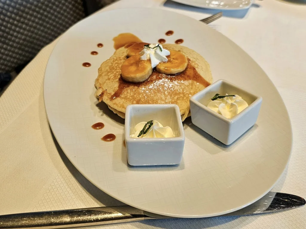 Cruising with Danny and Peter, Holland America Line, Westerdam, Nha Trang, Vietnam, Nha Trang Island Escapade Adventure | Group of tourists enjoying a Nha Trang Island Escapade Adventure featuring Mieu Island Exploration under a tropical sun, vibrant underwater scenes from Coral Reef Snorkeling in Nha Trang Bay, the pirate ship-shaped Tri Nguyen Aquarium showcasing a Marine Life Experience on a Vietnam Coastal Adventure, local fishermen feeding groupers during a Fishing Village Visit, relaxing on golden sands at Mini Beach Relaxation after a Nha Trang Island Tour with Holland America Cruise, and a scenic view of Nha Trang Bay from a boat during a Tropical Island Retreat.