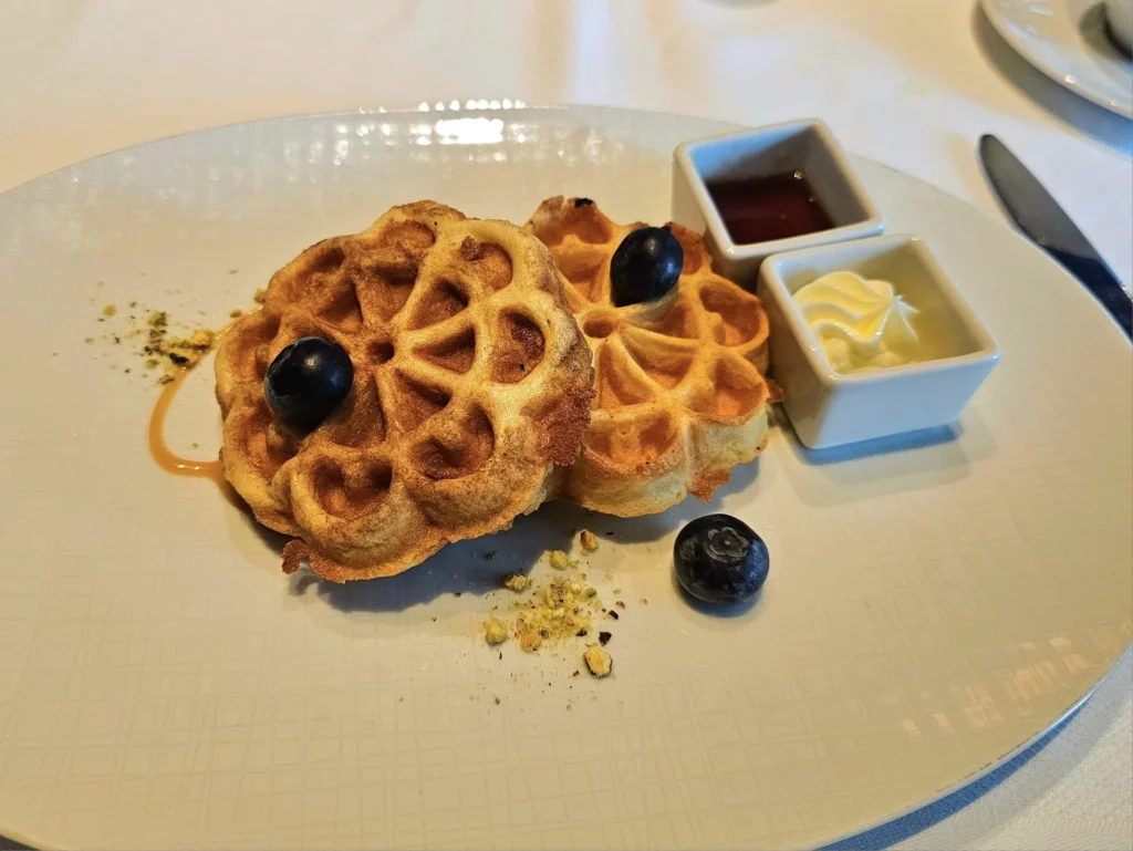 Cruising with Danny and Peter, Holland America Line, Westerdam, Nha Trang, Vietnam, Nha Trang Island Escapade Adventure | Group of tourists enjoying a Nha Trang Island Escapade Adventure featuring Mieu Island Exploration under a tropical sun, vibrant underwater scenes from Coral Reef Snorkeling in Nha Trang Bay, the pirate ship-shaped Tri Nguyen Aquarium showcasing a Marine Life Experience on a Vietnam Coastal Adventure, local fishermen feeding groupers during a Fishing Village Visit, relaxing on golden sands at Mini Beach Relaxation after a Nha Trang Island Tour with Holland America Cruise, and a scenic view of Nha Trang Bay from a boat during a Tropical Island Retreat.