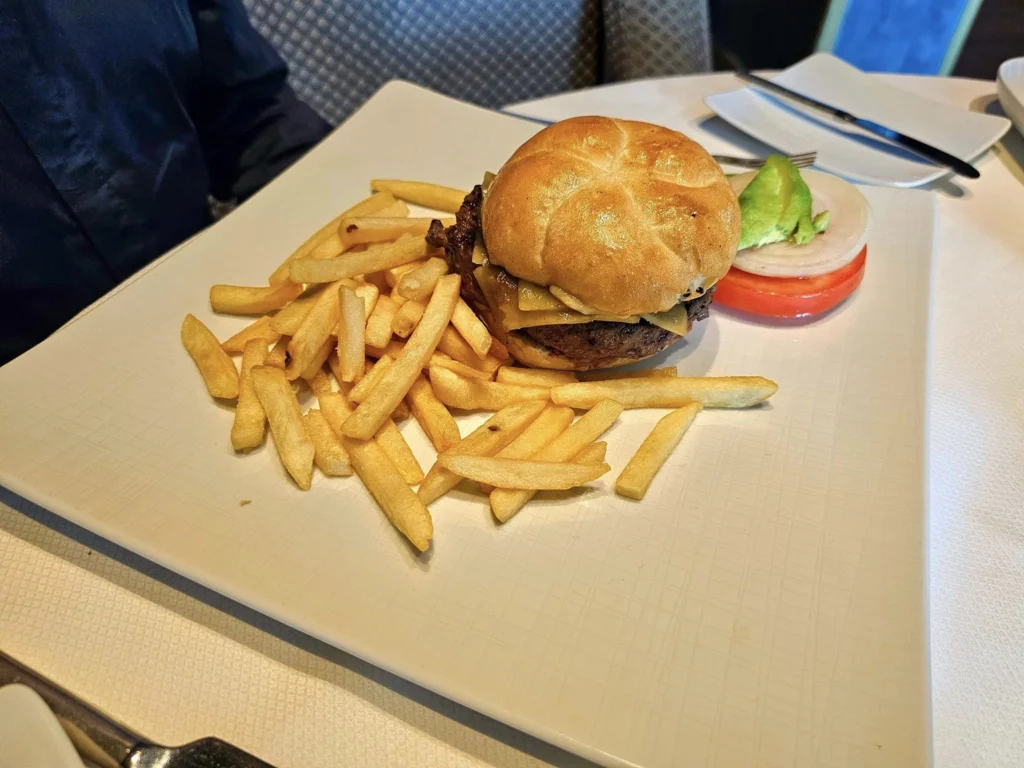 Cruising with Danny and Peter, Holland America Line, Westerdam, Nha Trang, Vietnam, Nha Trang Island Escapade Adventure | Group of tourists enjoying a Nha Trang Island Escapade Adventure featuring Mieu Island Exploration under a tropical sun, vibrant underwater scenes from Coral Reef Snorkeling in Nha Trang Bay, the pirate ship-shaped Tri Nguyen Aquarium showcasing a Marine Life Experience on a Vietnam Coastal Adventure, local fishermen feeding groupers during a Fishing Village Visit, relaxing on golden sands at Mini Beach Relaxation after a Nha Trang Island Tour with Holland America Cruise, and a scenic view of Nha Trang Bay from a boat during a Tropical Island Retreat.