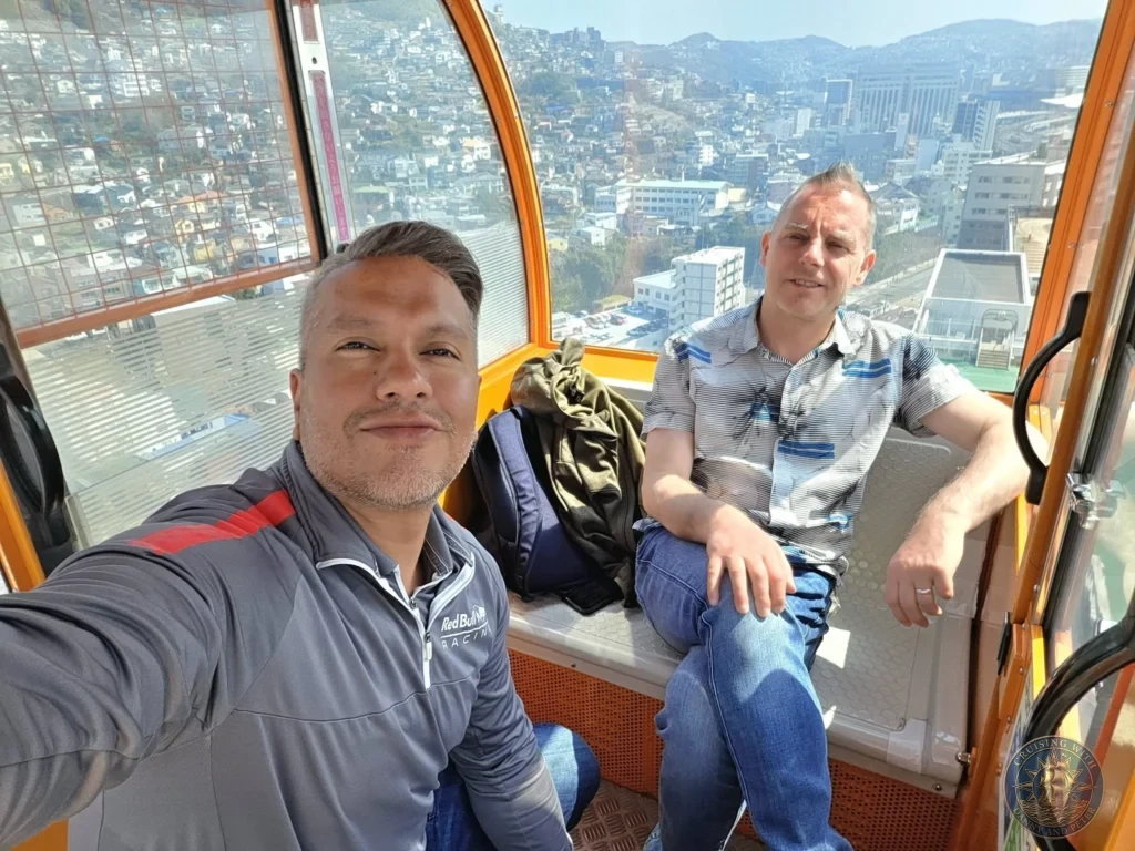 Selfie inside the Mirai Nagasaki Coco Walk Ferris wheel gondola with Danny and Peter enjoying breathtaking panoramic views over Nagasaki city, hills, and harbor — a highlight in Nagasaki Japan cruise port guide. Perfect for things to do in Nagasaki from cruise ship and one day in Nagasaki Japan itinerary when exploring from the Westerdam by Danny and Peter.
