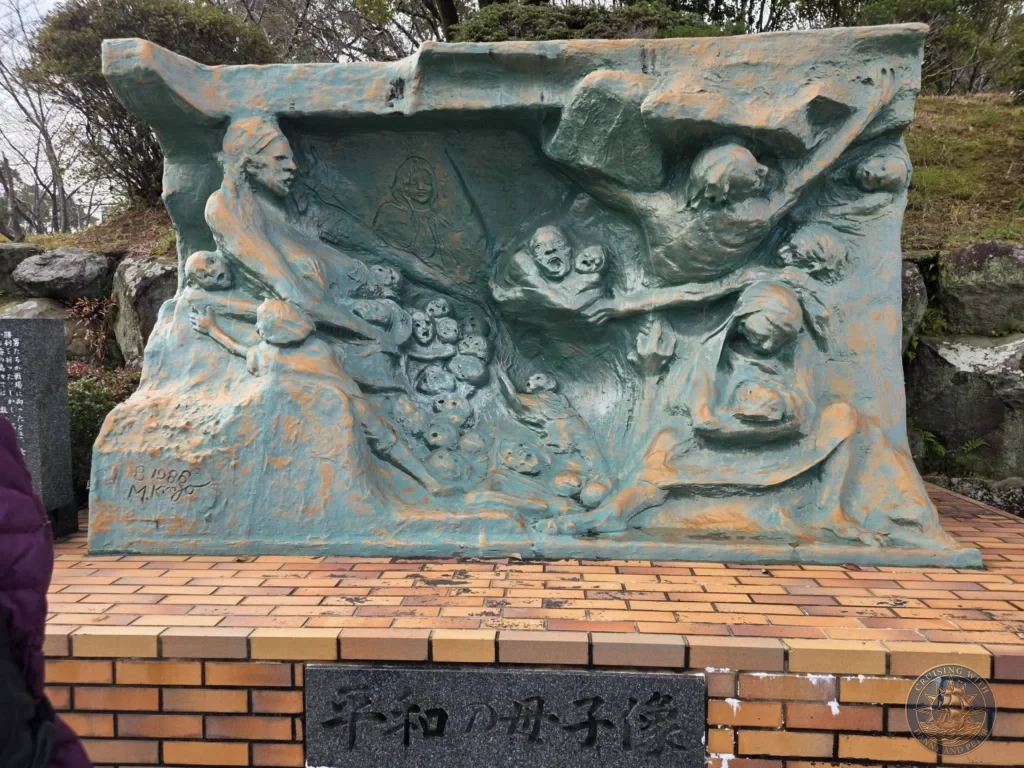 Peace Statue of Mother and Child at the Hypocenter Park in Nagasaki, Japan — a powerful memorial sculpture showing a mother protecting her children amid the devastation of the atomic bombing. Featured in Nagasaki Japan cruise port guide and one day in Nagasaki Japan itinerary when visiting from the Westerdam cruise ship by Danny and Peter.