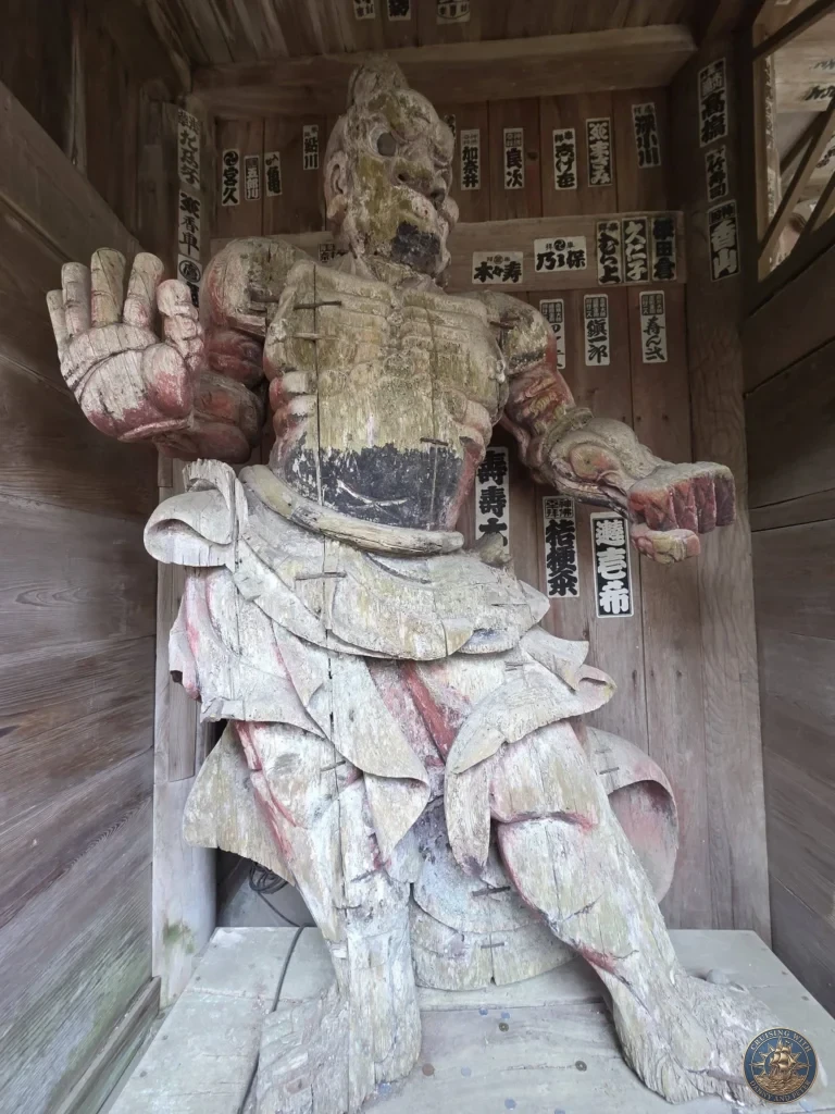 Impressive large wooden Niō guardian statue with vibrant colors and powerful expression at Chikurin Temple in Kochi, Japan. Historic temple protector figure carved from wood. Kochi Cruise Port Guide | Things to do in Kochi from cruise ship | One day in Kochi Japan itinerary by Danny and Peter.