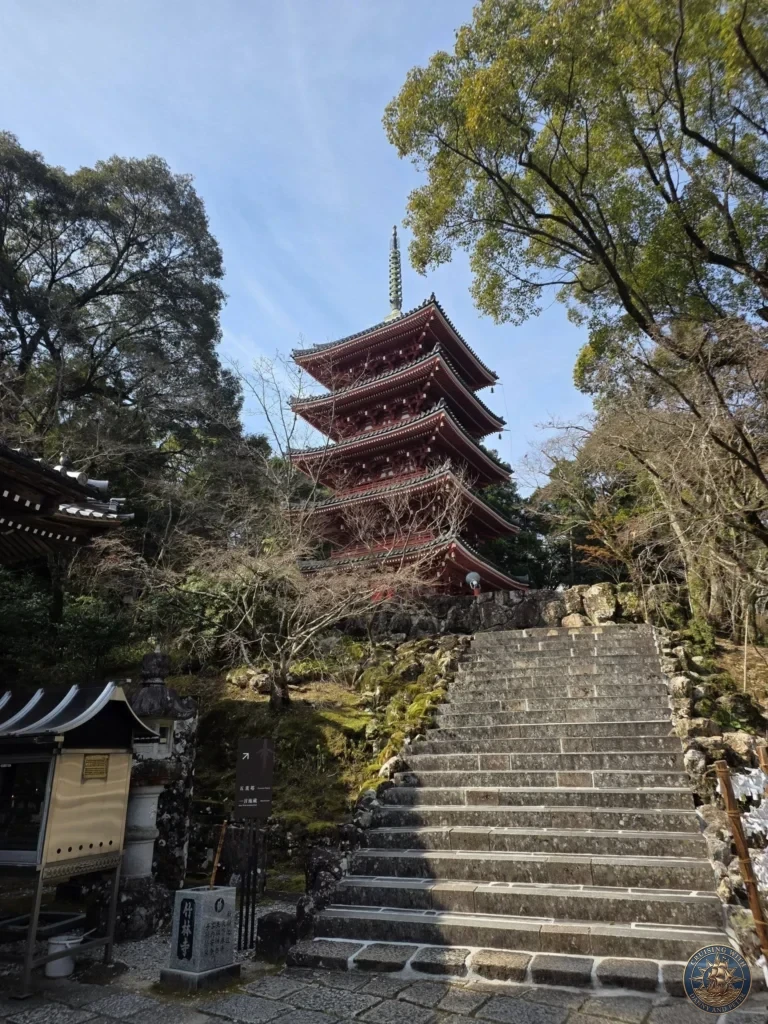 Iconic five-story red pagoda towering above stone stairs at Chikurin Temple in Kochi, Japan. Beautiful traditional temple architecture surrounded by lush trees. Kochi Cruise Port Guide | Things to do in Kochi from cruise ship | One day in Kochi Japan itinerary by Danny and Peter.