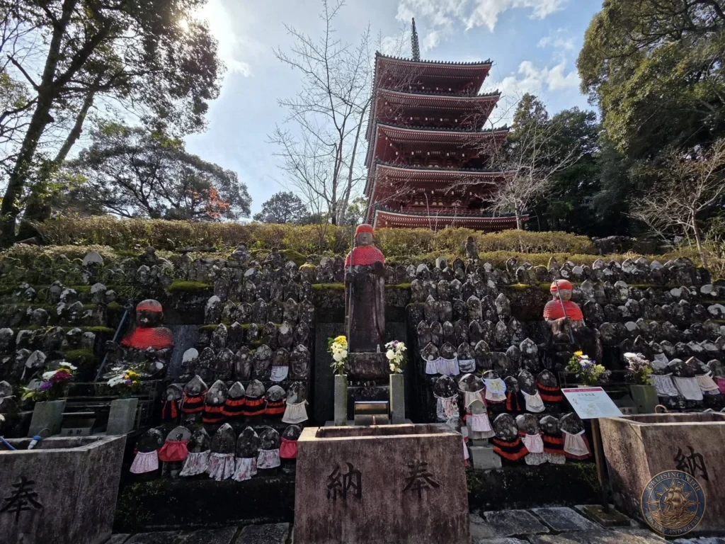 Numerous Jizo statues arranged on stone terraces with the iconic five-story red pagoda towering in the background at Chikurin Temple in Kochi, Japan. Iconic temple landscape. Kochi Cruise Port Guide | Things to do in Kochi from cruise ship | One day in Kochi Japan itinerary by Danny and Peter.