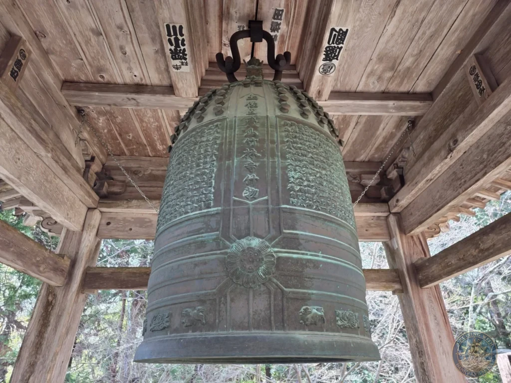 Close-up of the large bronze temple bell with detailed inscriptions and carvings at Chikurin Temple in Kochi, Japan. Historic bell in a wooden pavilion. Kochi Cruise Port Guide | Things to do in Kochi from cruise ship | One day in Kochi Japan itinerary by Danny and Peter.