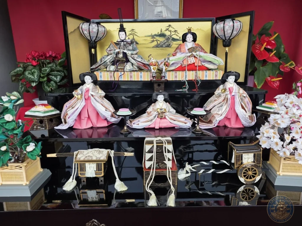 Beautiful traditional Hina-ningyo (Emperor and Empress) doll display with ornate kimonos, miniature furniture, lanterns, and accessories at the Chiran Doll & Toy Museum in the Chiran Samurai District. Stunning exhibit in Kagoshima, Japan. Kagoshima Cruise Port Guide | Things to do in Kagoshima from cruise ship | One day in Kagoshima Japan itinerary by Danny and Peter.